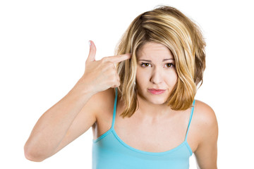 Fototapeta premium Woman gesturing with finger against temple asking are you crazy 