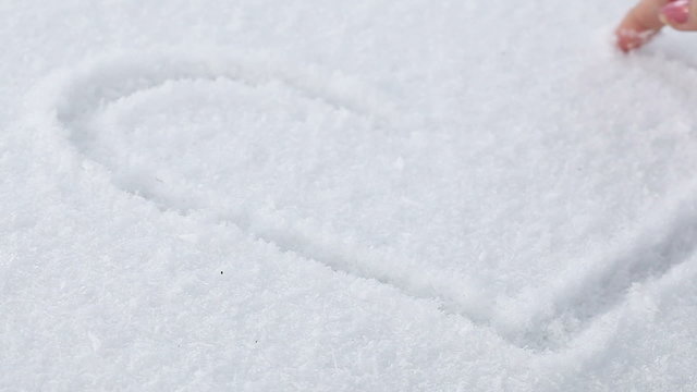 Drawing heart in snow