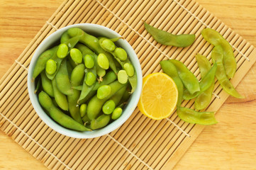 Edamame, soy beans on a wooden background
