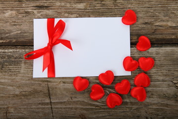 Greeting card with red bow and hearts