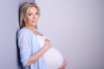 beautiful forty years old pregnant woman with blue shirt 