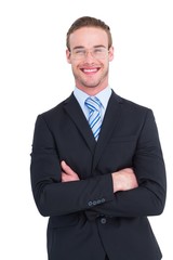 Smiling businessman in suit with arms crossed