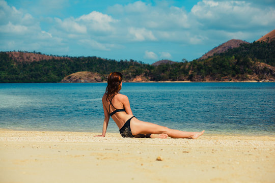 Beautiful young woman relaxing on tropical beach