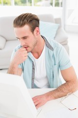 Fototapeta premium Concentrated businessman typing on keyboard