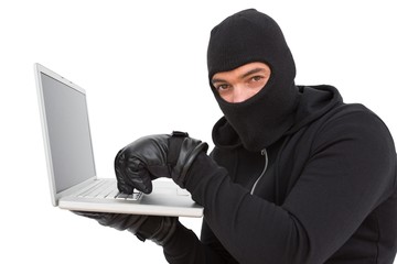 Hacker using laptop to steal identity