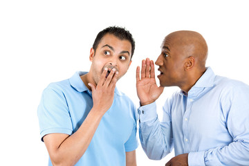 guy whispering into man's ear telling him something secret 