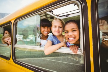 Cute mixed race pupils smiling at camera in the school bus © WavebreakMediaMicro