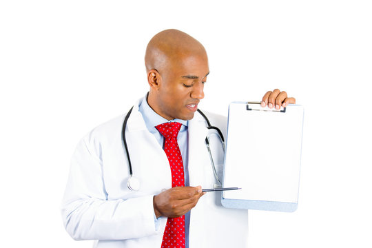 Doctor showing blank clipboard to write it on copy space 