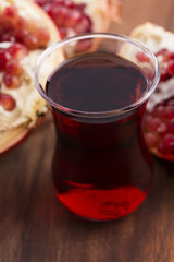 Ripe pomegranates with juice on table