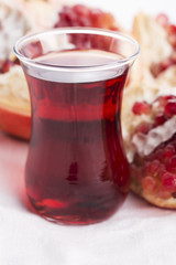 Ripe pomegranates with juice on table