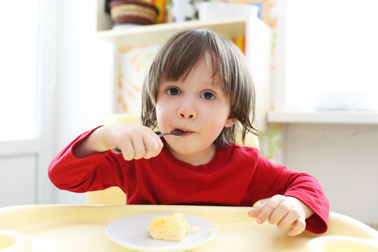 Toddler In Red Shirt Eating Omelet