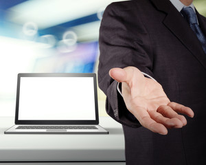 businessman and blank laptop computer in shop background as conc