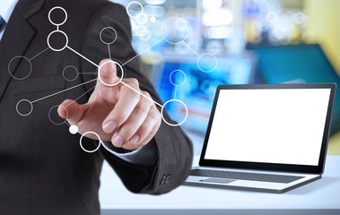 hand showing blank flow chart and blank laptop computer in shop
