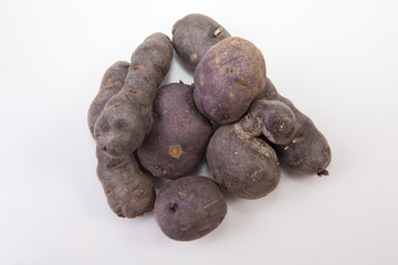 Handfull of Vitelotte potatoes