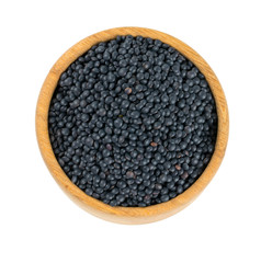 black lentils in a bowl isolated on white