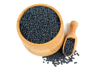 black lentils in a bowl isolated on white