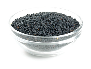black lentils in a bowl isolated on white