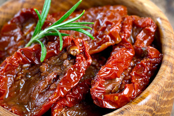 sun dried tomatoes with olive oil on wooden surface