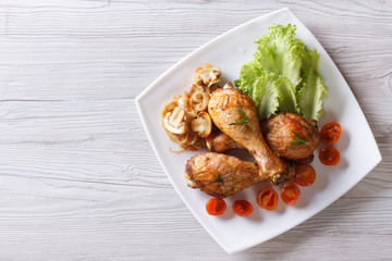 chicken legs with mushrooms and tomatoes horizontal top view