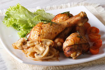 Delicious chicken legs with mushrooms Horizontal close-up