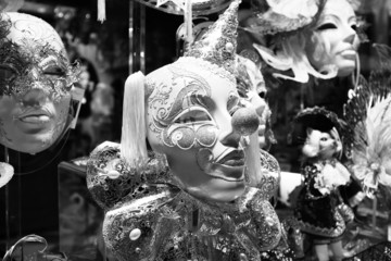 Various carnival masks on sale on a wall in a shop
