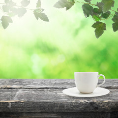 Table with coffee cup on nature