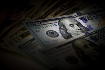 Many US dollars banknotes as background. 