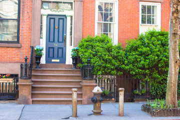 Old houses with stairs in the historic district of West Village