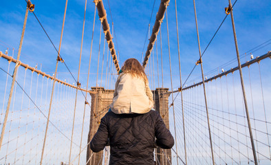 Dad and little girl on Brooklyn bridge, New York City, USA