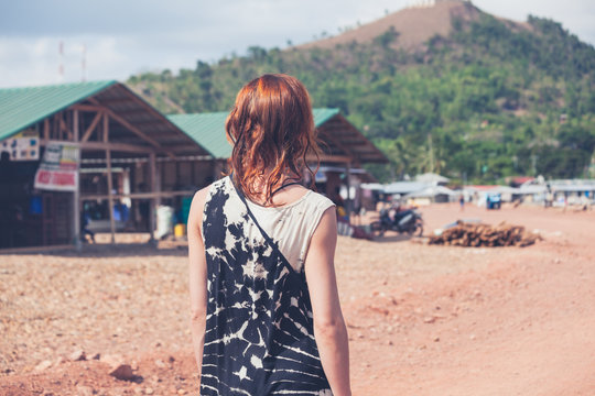 Young woman walking in a small town in developing country