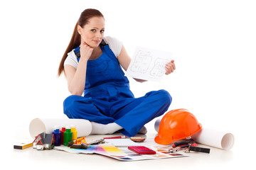 Female construction worker with plan of house.