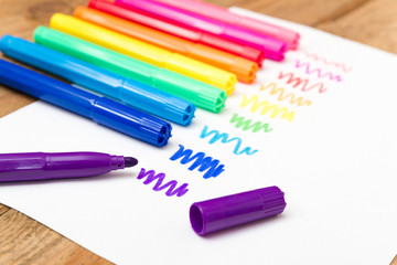 A set of markers on a sheet of white paper.Concept.Drawing of di