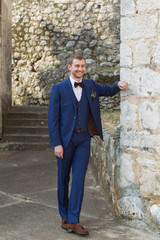 Fototapeta na wymiar handsome groom in a blue suit
