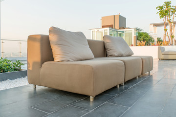 Chairs and a couch provide a place from a highrise rooftop