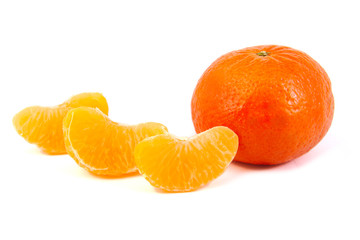 Three tangerine slices with a mandarin on white background