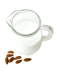 Almond milk in jug on a white background seen from above