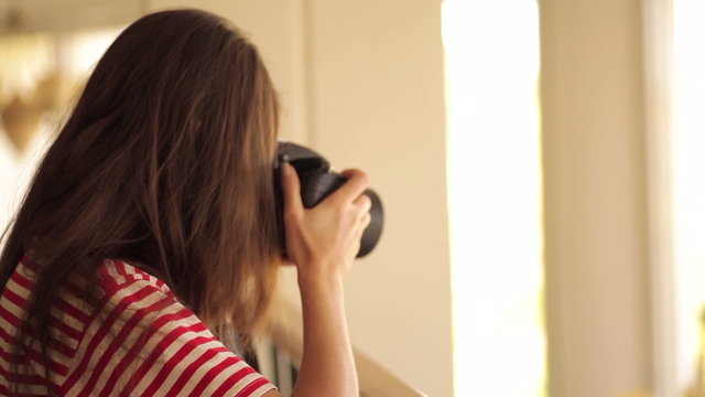 Young girl taking a pic with camera