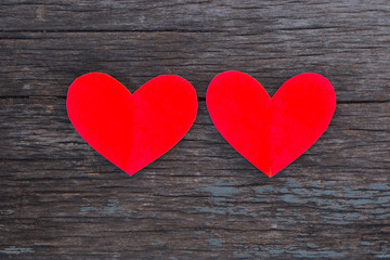 red heart made of paper on wooden background.