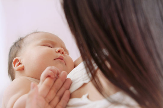 soft image of cute newborn baby with mother