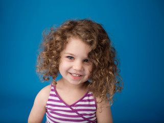 Happy Smiling Laughing Child: Girl with Curly Hair