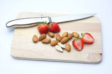 Strawberries and almonds on chopping block