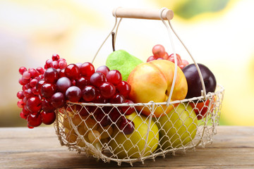 Assortment of juicy fruits in wicker basket