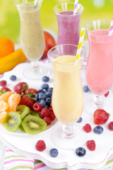 Delicious berry cocktails on table on bright background