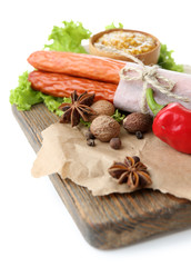 Smoked thin sausages, mustard in bowl and spices