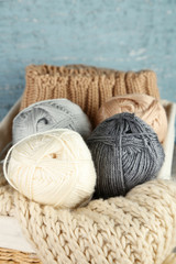 Fototapeta na wymiar Knitting yarn in basket, on wooden background