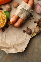 Composition of thin sausages, mustard in bowl and spices