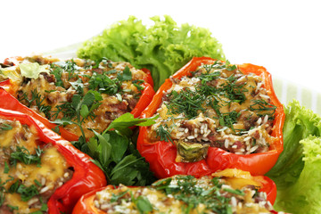 Stuffed red peppers on plate on napkin close up