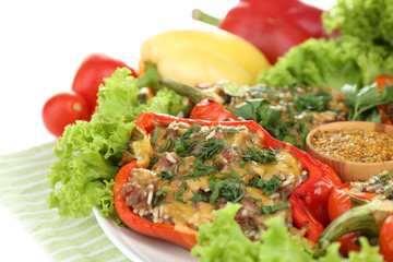 Stuffed red peppers on plate on napkin close up