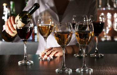 Bartender working at counter on bar background