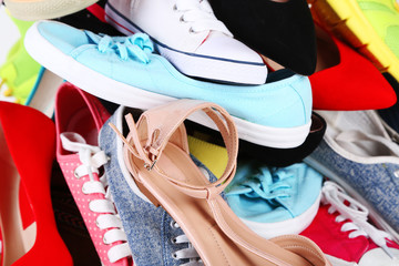 Many various female shoes close-up background